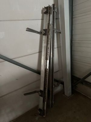 several pieces of metal are leaning against a wall in a garage
