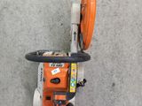an overhead view of a chainsaw on a concrete floor