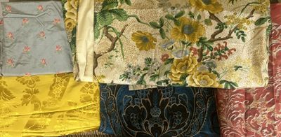 many different fabrics laid out on a table
