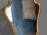 a mirror hanging on a wall in a room