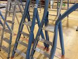 many ladders that are sitting on the floor in a warehouse