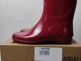 an image of a pair of red rain boots sitting on top of a box