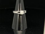 a close up of a ring with a diamond on top of a cone