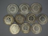 six different types of silver coins are arranged in a circle