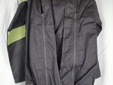 the jacket is hanging on a hanger on the wall