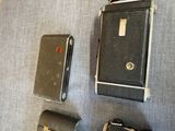 three different types of cameras sitting on a table