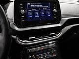 the interior of a car with a steering wheel and a touch screen