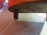 a close up view of a wooden bench on the ground
