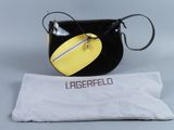 une image représentant un sac à main noir et jaune, avec un sac blanc posé en dessous