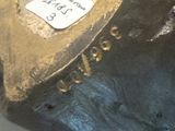 a close up of a statue of a dog with a tag on it ' s collar