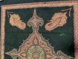 a black and red rug with a design on it