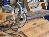 someone is using a chainsaw to cut a piece of wood on a table