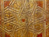 an image of a gold and red tile with a star design on it