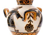a black and white vase with an orange design on it