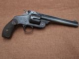 a close up of a revolver on a brown background