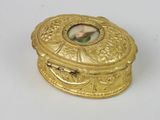 a gold box with a picture of a woman on it