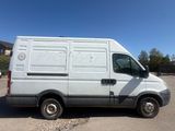 a white van parked in a parking lot with a blue sky in the background