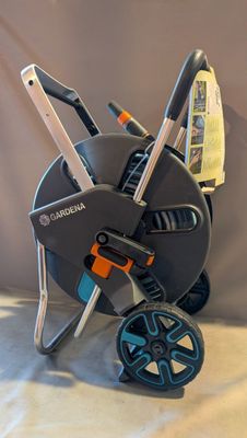 a small child ' s stroller that is sitting on a bed