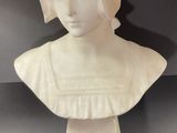 white marble bust of a woman with a turban on her head