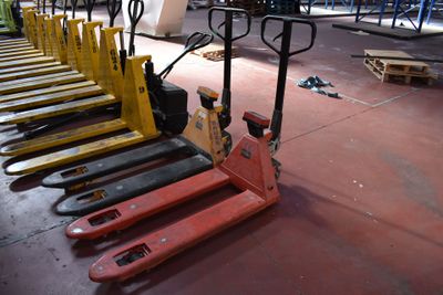 many forklifts lined up in a row on the floor