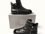 a pair of black boots that are sitting on a box