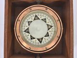 an old wooden box with a compass in it on a white background