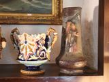 three vases sitting on a shelf in front of a painting