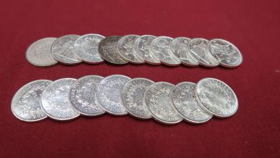a close up of a bunch of silver coins on a red surface