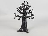 a black sculpture of a tree with branches and birds on it