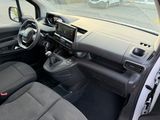 the interior of a small car with a steering wheel and dashboard