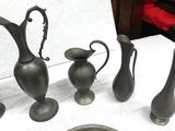 a lot of vases that are sitting on a table