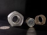 three different types of clocks sitting on a table