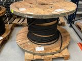 a wooden table with a spool on top of it in a warehouse