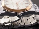 a close up of a watch on a metal bracelet
