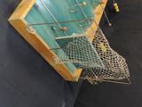 a fishing net hanging on the wall next to a fishing net