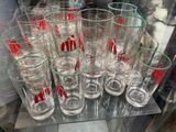 a lot of glasses that are sitting on a glass shelf
