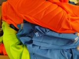 a pile of clothes sitting on top of a wooden table