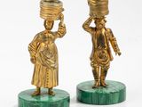 pair of brass figurines of women carrying pots on their heads