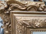 a gold frame with a picture of a bird on it