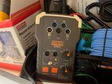 a suitcase filled with electronics and other items on the table