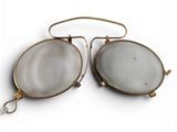 pair of gold and white glass earrings on a white background