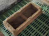 a planter that is sitting on a grate on the floor