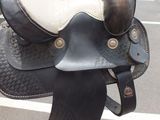 a close up of a horse ' s saddle in a parking lot