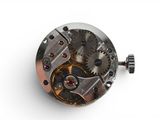 an image of a close up of a watch mechanism on a white surface