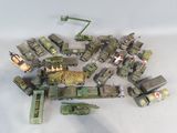 a lot of toy army vehicles on a white surface
