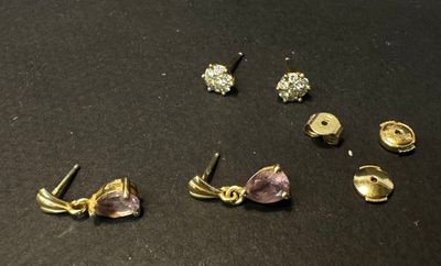 a close up of a bunch of earrings on a table