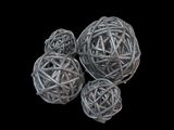 three balls of rattan on a black background with a black background