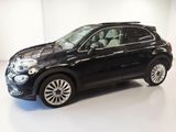the black fiat suv is parked in a white room
