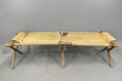 an image of a wooden bench with two legs on a gray floor