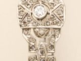 a silver watch with a diamond in the middle of it